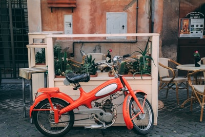 Glass beside the red bike
